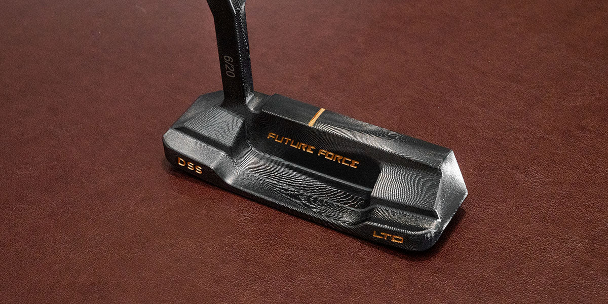 Close-up of the Black Damascus DSS LTD putter face, showing precision-milled texture and gold alignment line.